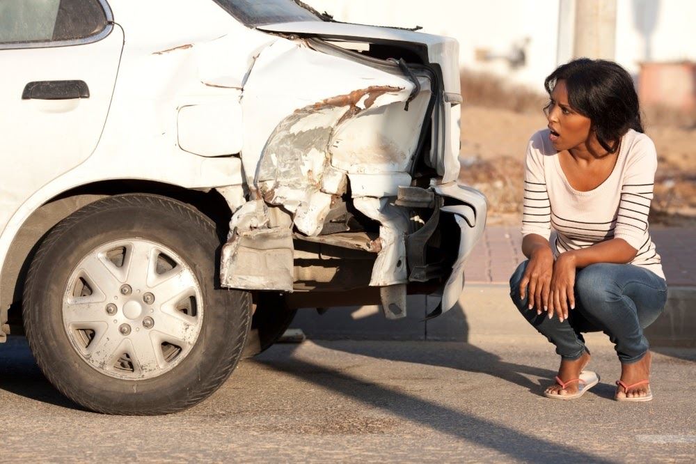 Woman looking at rear end accident