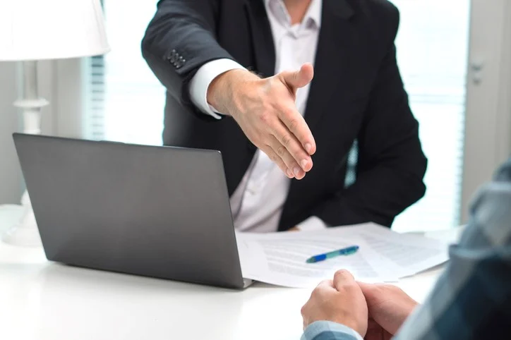 man reaching out to shake hand