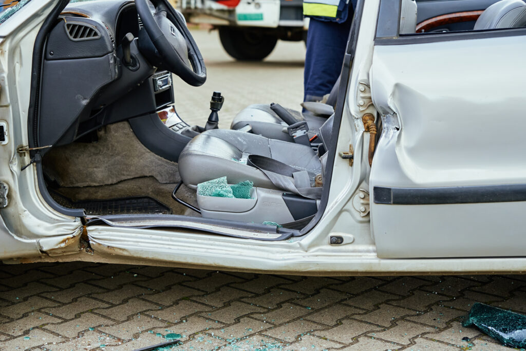 Damaged car interior after a Georgia accident with shattered glass and a steering wheel where the airbag failed to deploy.